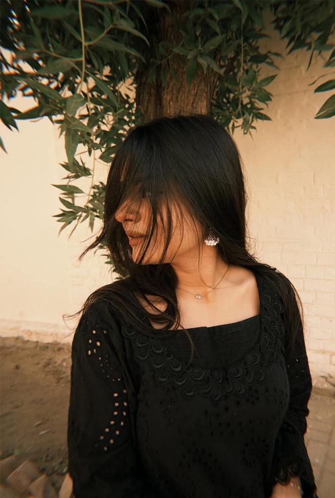 Tanisha Independent Escorts graceful profile pose in black traditional outfit