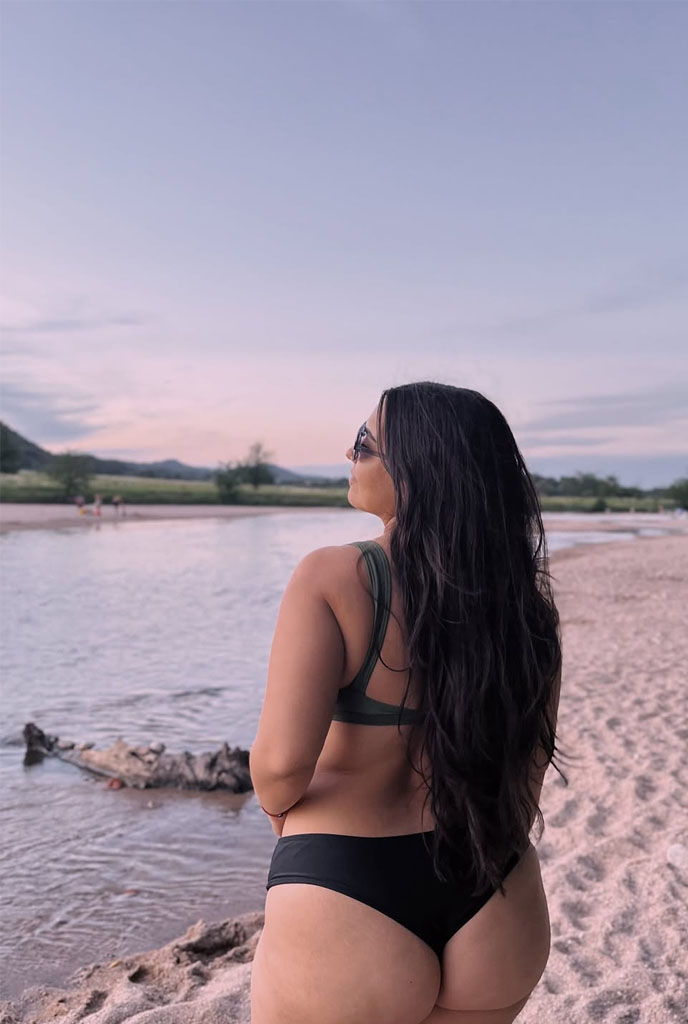 Poulomi VIP Escorts posing by riverside in stylish bikini at sunset in Siliguri