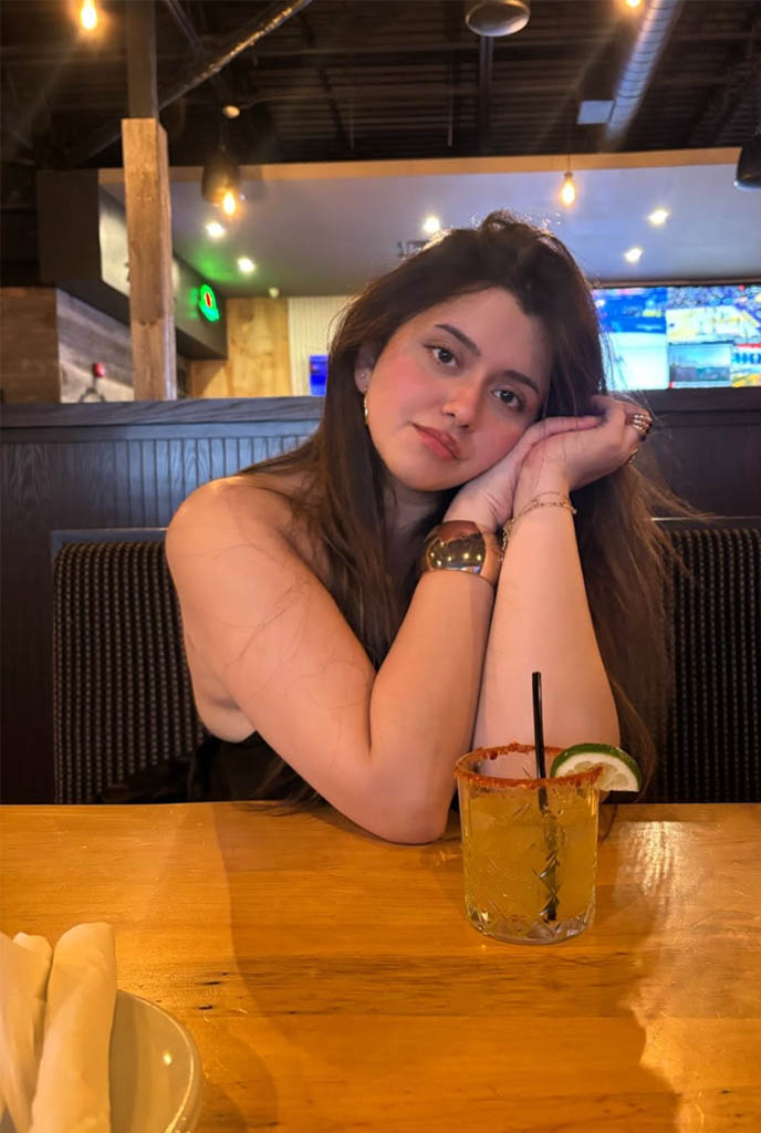 Tiya Celebrity Escort enjoying a classy dinner date in stylish black outfit at a luxury restaurant