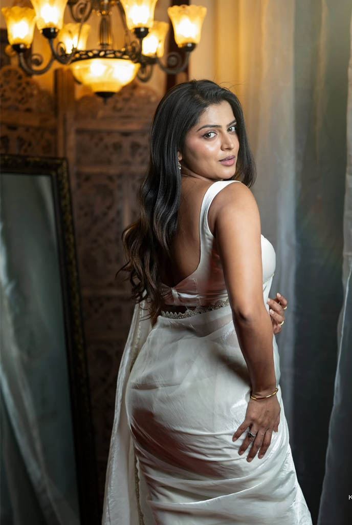 Ishani Model Escorts in elegant white saree posing indoors with warm lighting