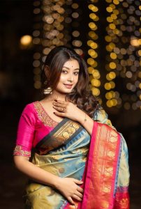 Nimisha Housewife Escort wearing an elegant saree during a graceful night photoshoot with warm bokeh lights