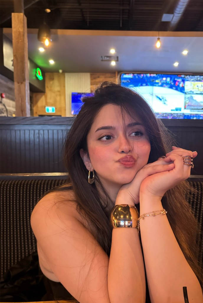 Tiya Celebrity Escort posing with charming expression at an upscale lounge setting