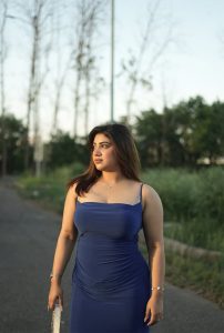 Aashmita Roy VIP Escorts in Siliguri wearing elegant blue dress standing outdoors with confident look